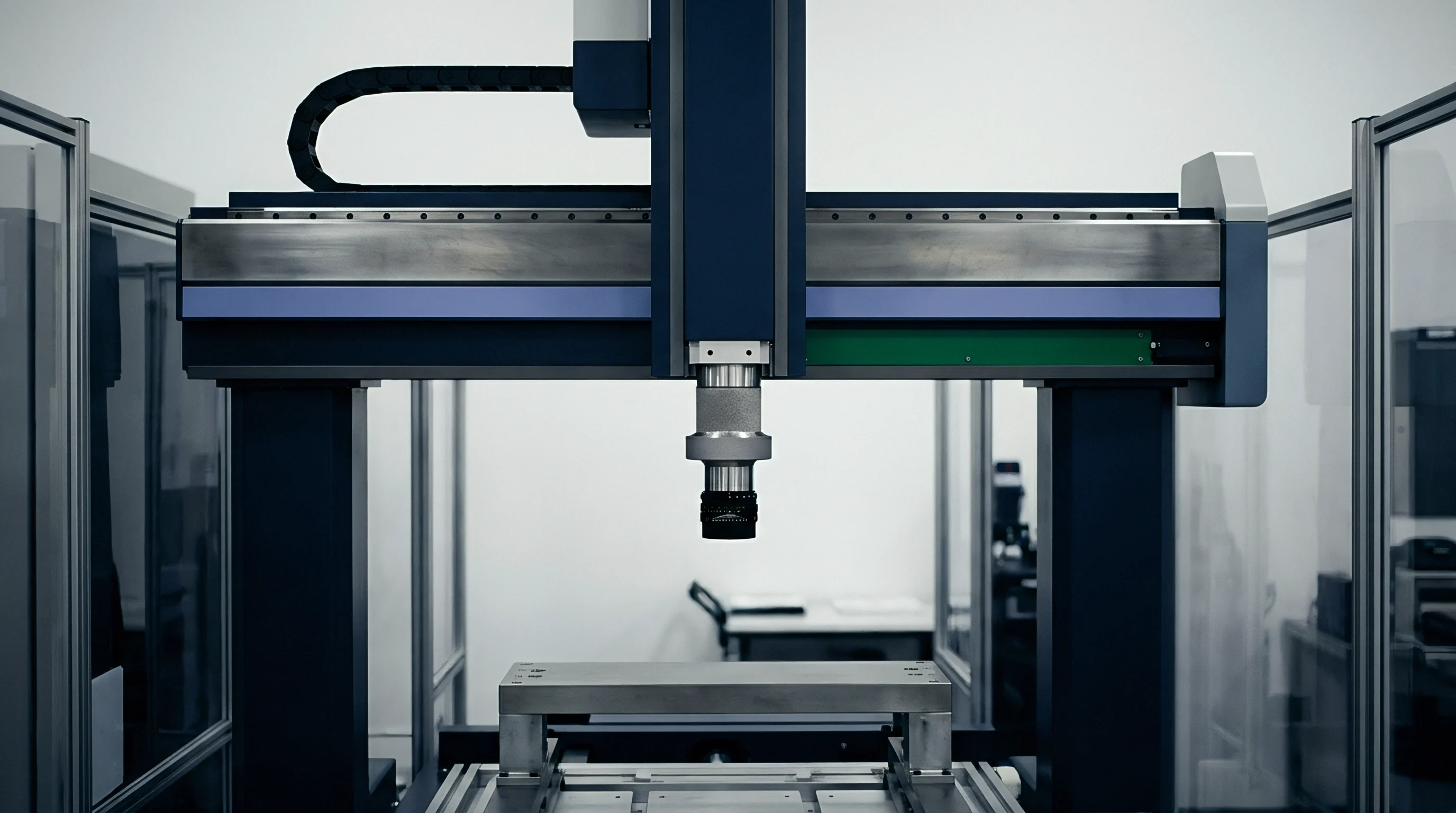An automated gantry system supports a precision optical sensor above a horizontal mounting fixture within a clean industrial assembly enclosure.