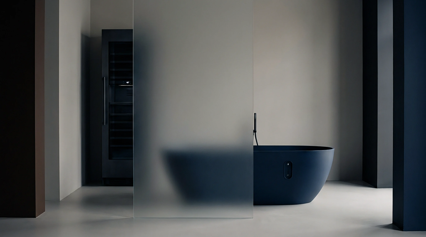 A dark matte composite vessel featuring an embedded digital interface sits beside a frosted glass partition within a neutral technical enclosure.