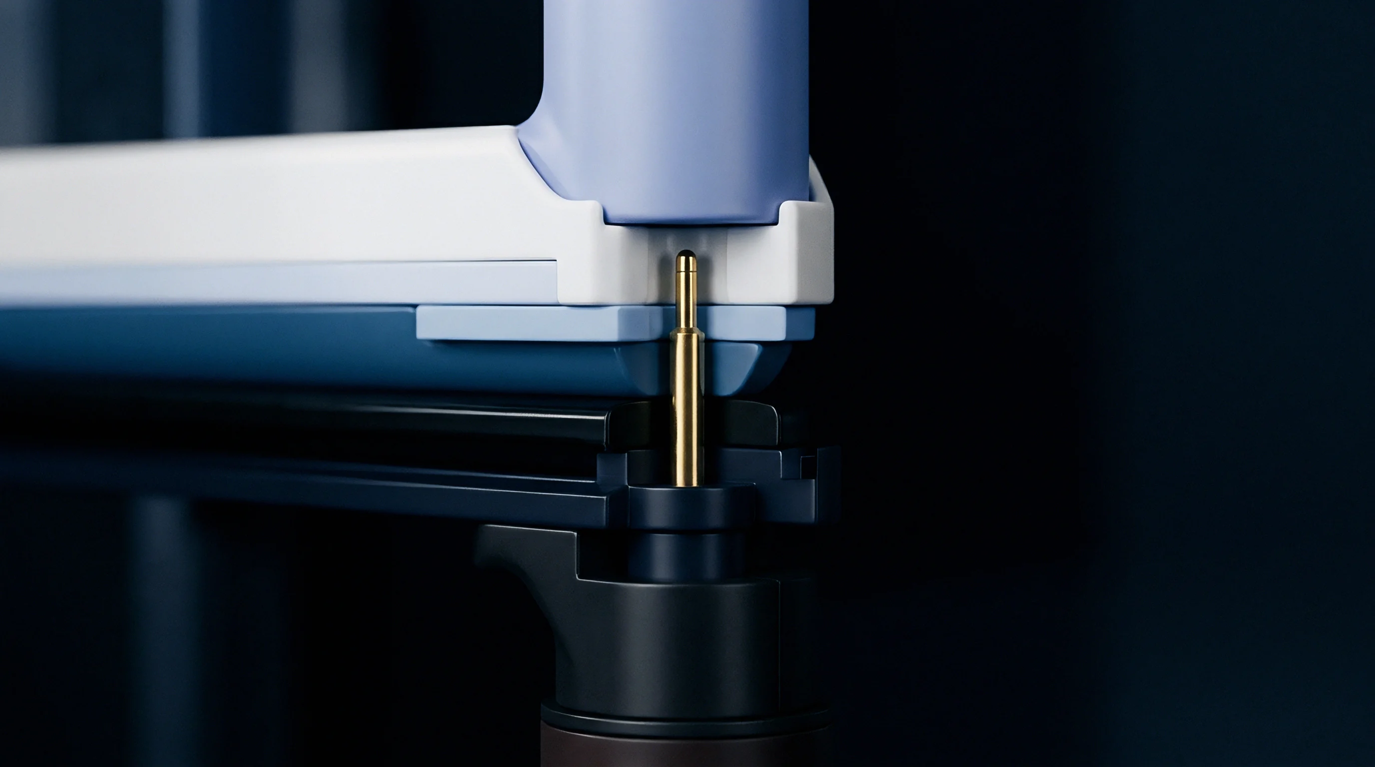 A gold finished spring pin stands vertically between blue and white polymeric components inside an energy storage module.